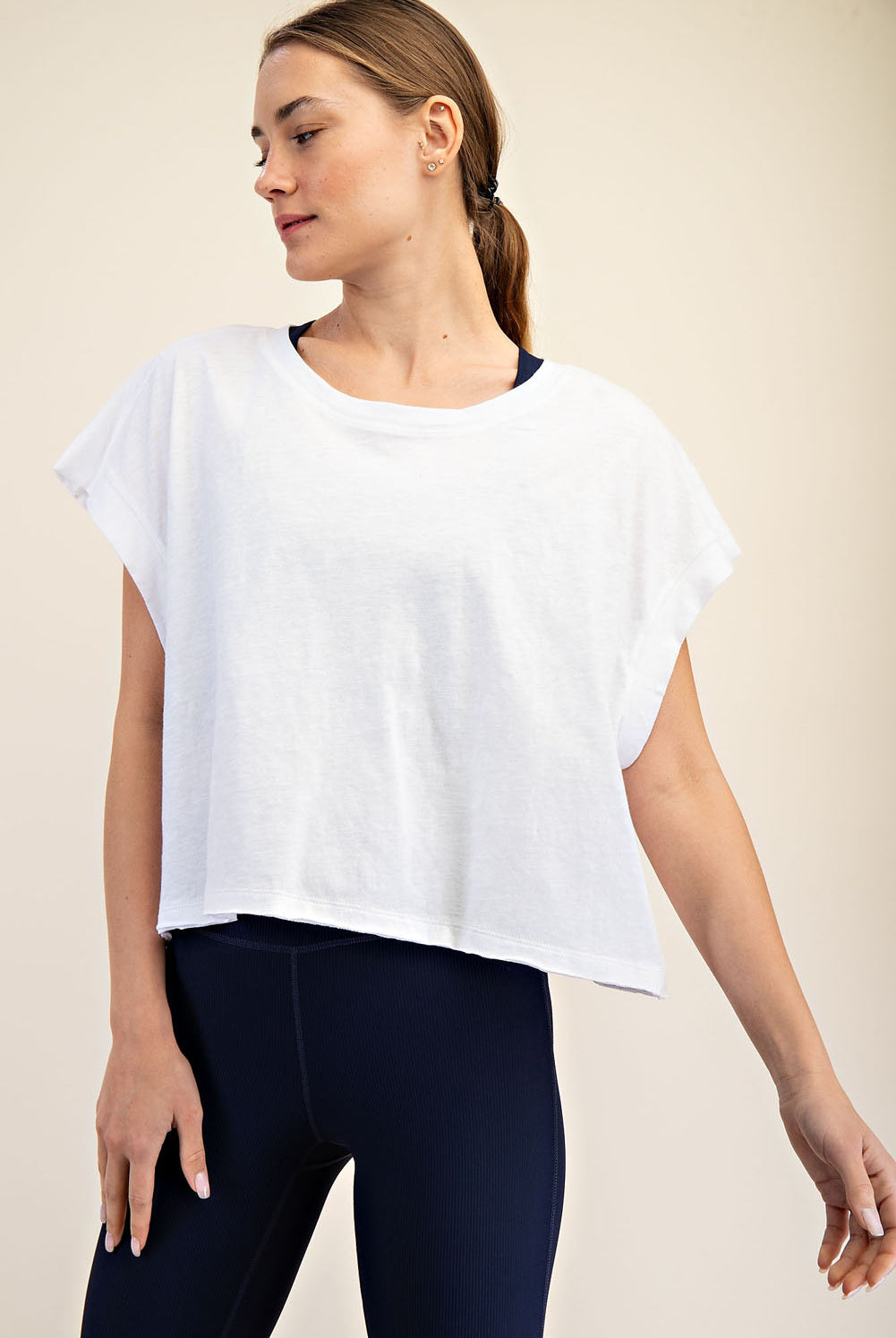 Woman wearing a white top with open back