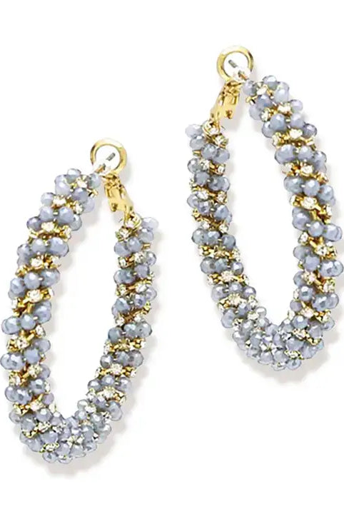 Blue and gold earrings on white background
