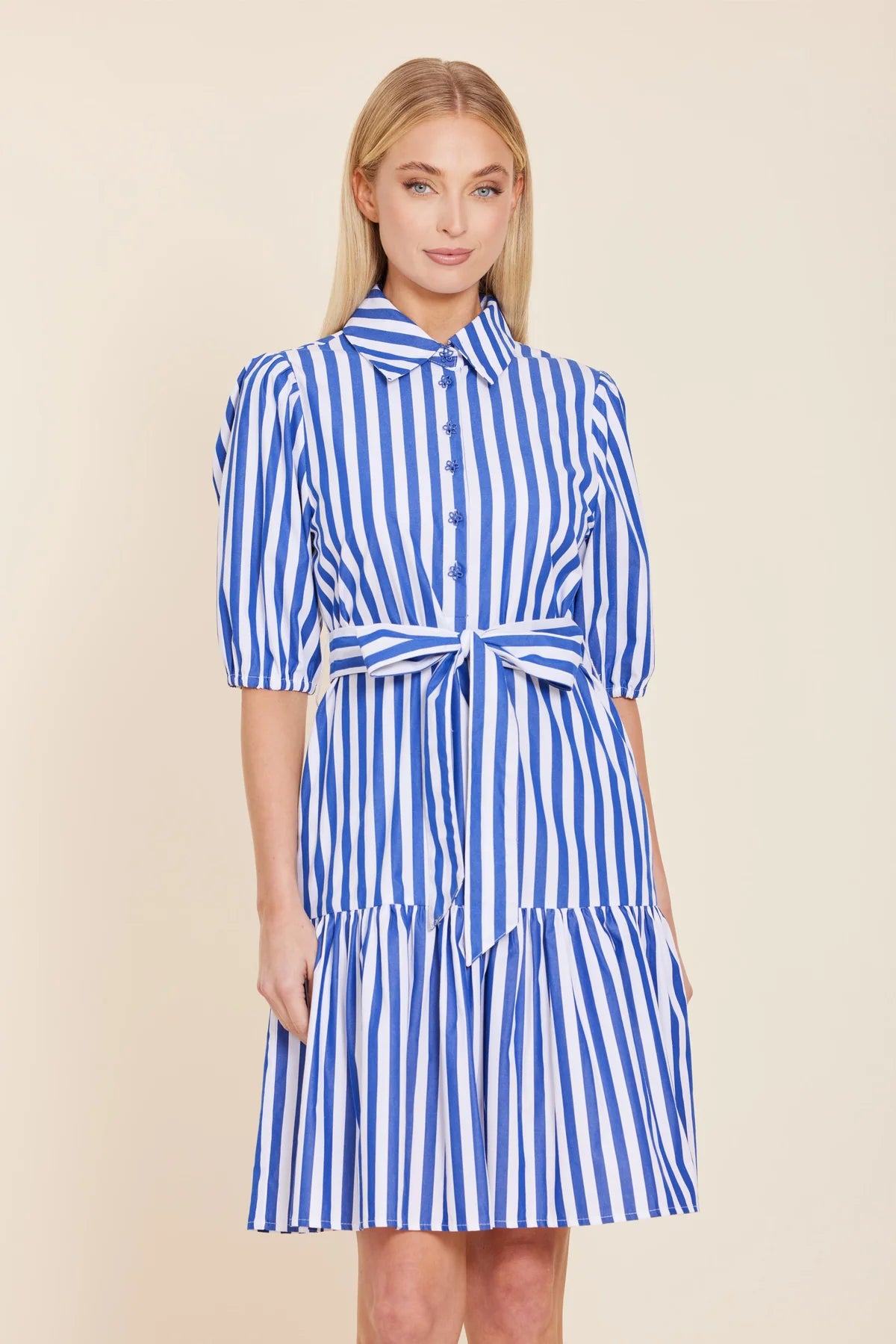 Woman wearing a blue and white striped dress