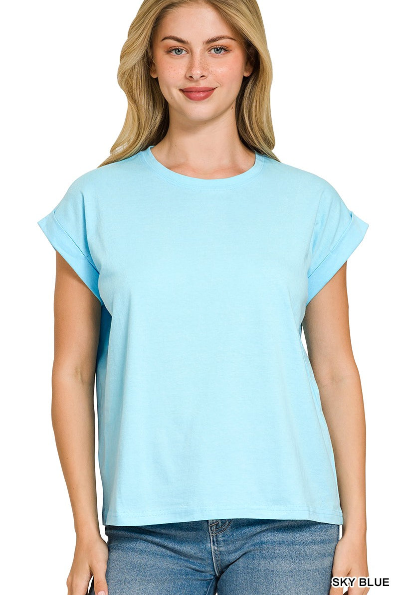 Woman wearing a light blue t-shirt with folded sleeves