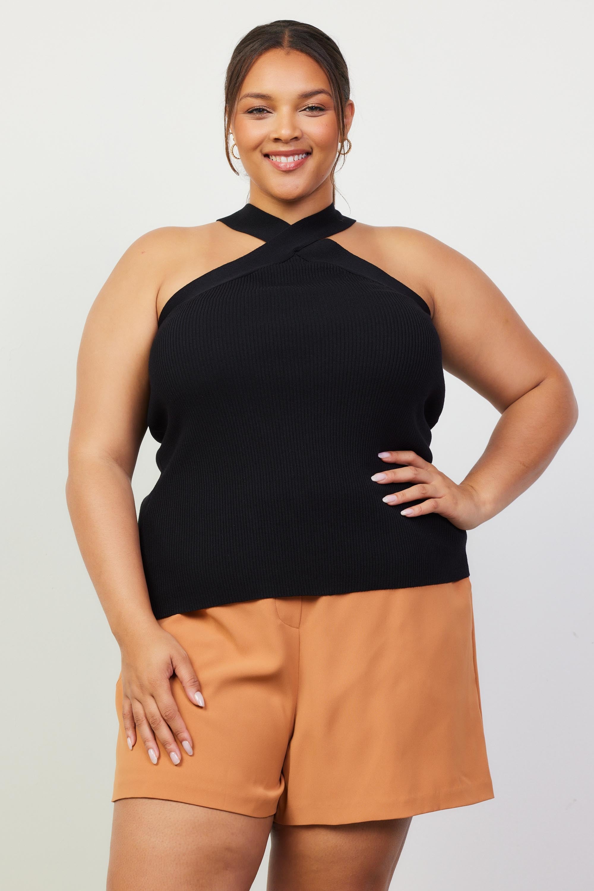 Woman wearing a black crossed neck top