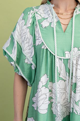 Green babydoll dress with white floral pattern