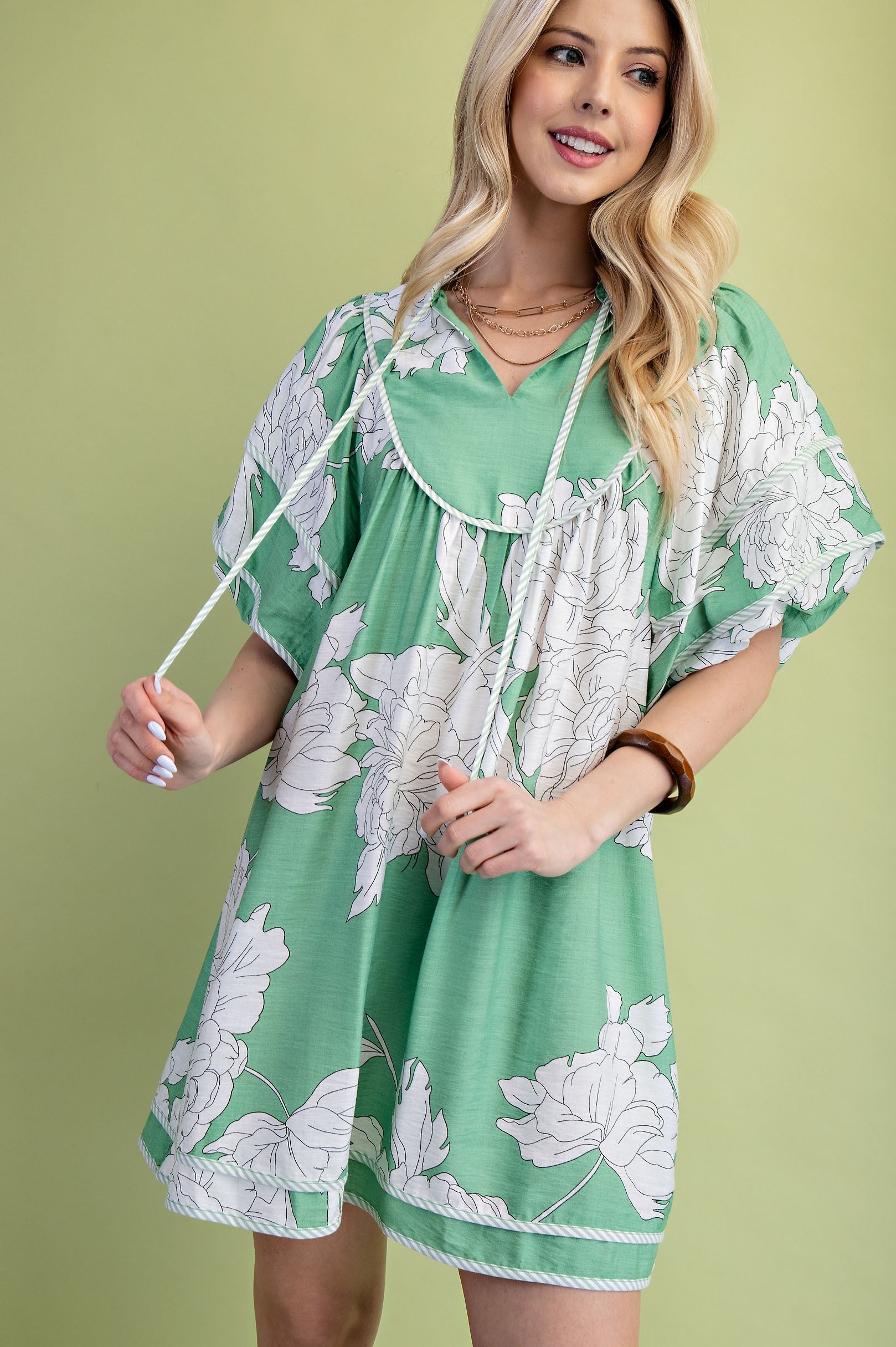Woman wearing a green floral babydoll dress
