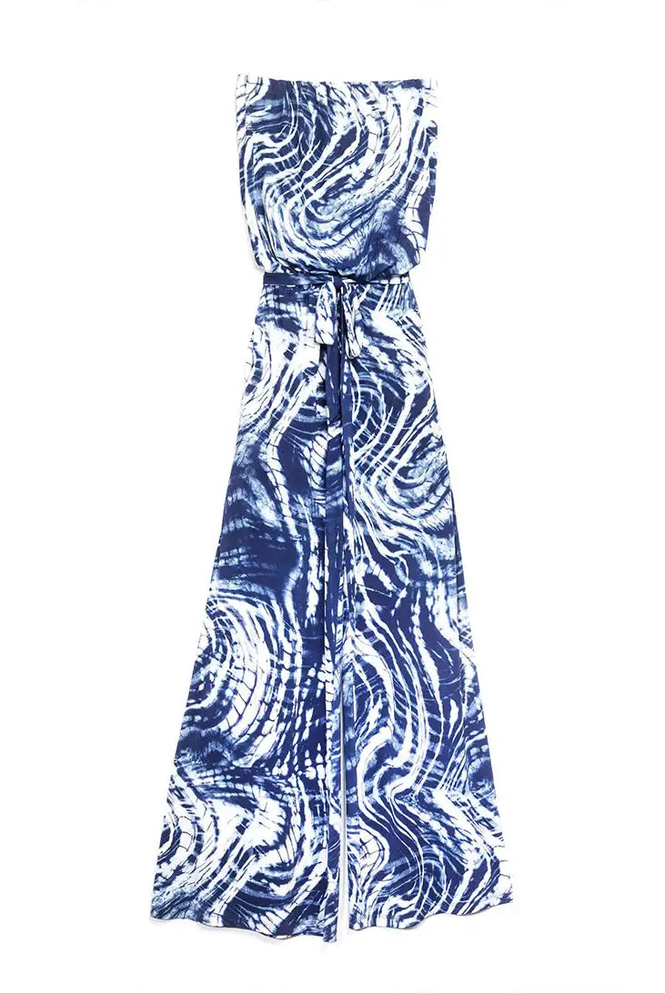 A sleeveless wrap maxi dress with a blue and white tie-dye swirl pattern, featuring a tie waist and a draped front, shown against a plain white background.