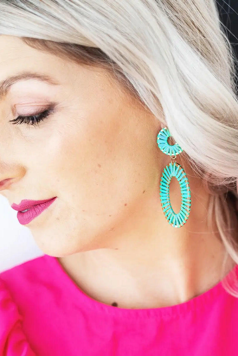 Model wearing aqua earrings