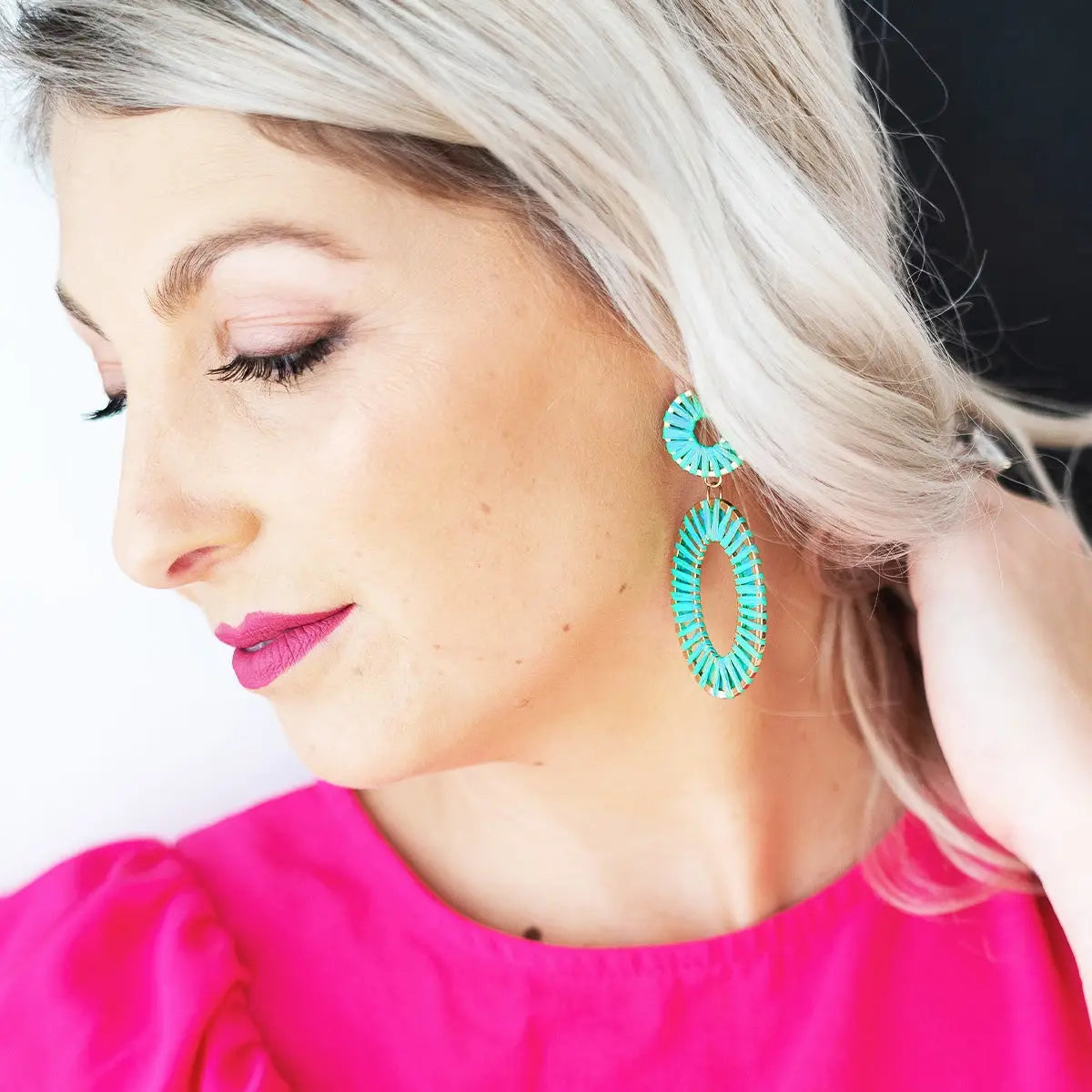 Model wearing aqua earrings