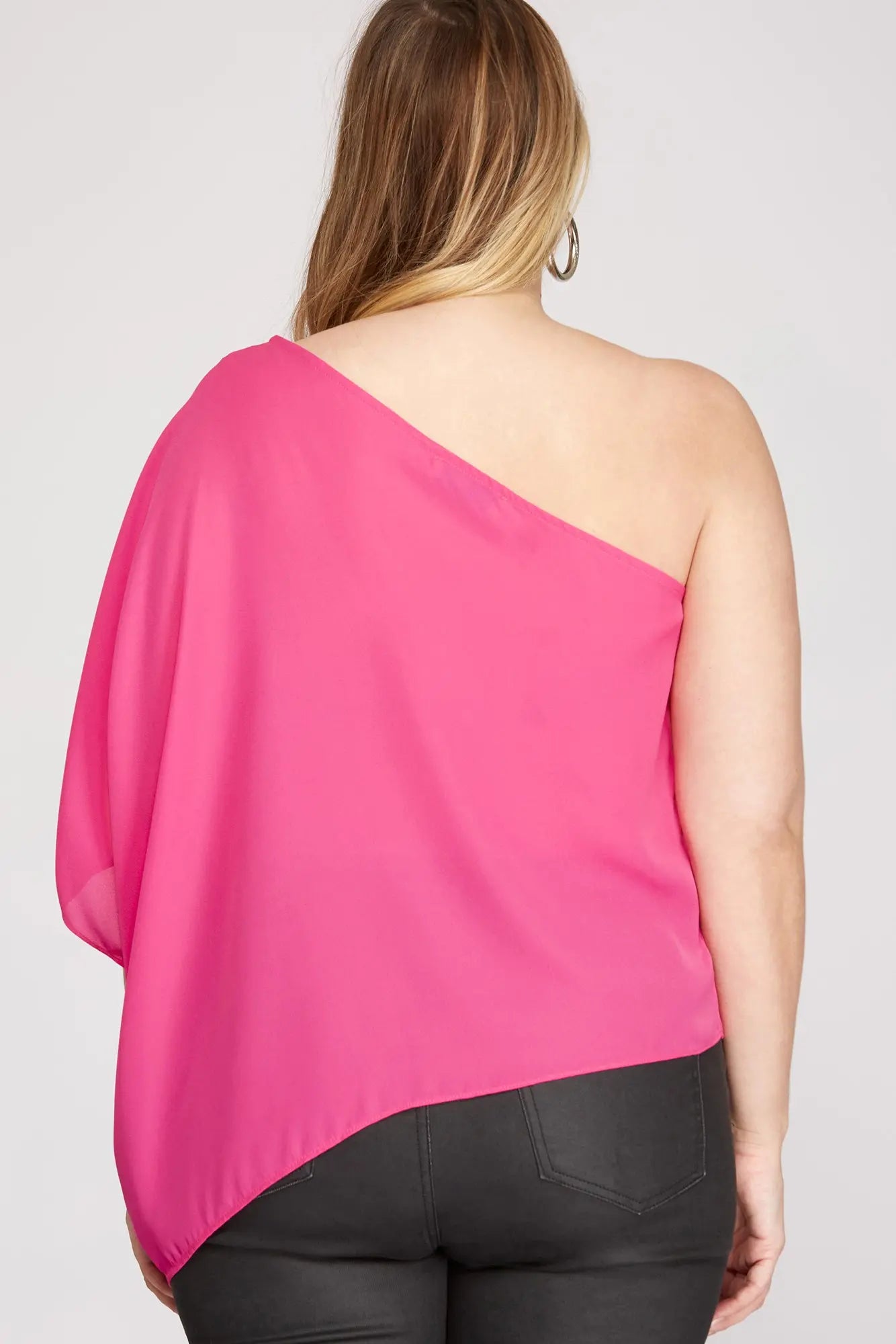 Back of woman wearing a bright pink one-shoulder top