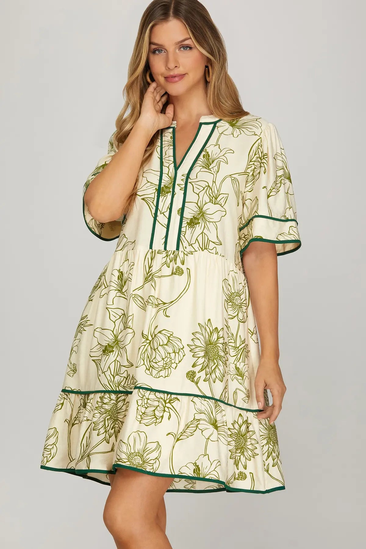 Woman wearing a floral dress with green accents