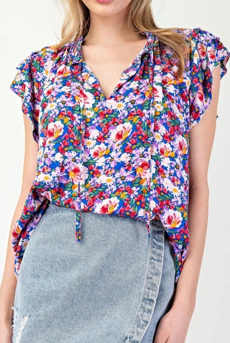 Model wearing royal blue floral tank with jean skirt