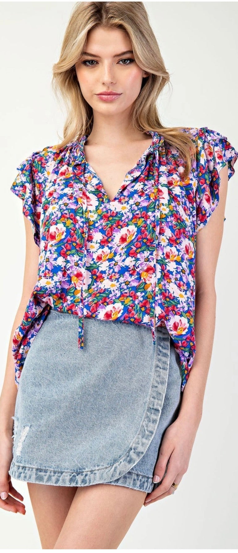 Model wearing royal blue floral tank with jean skirt