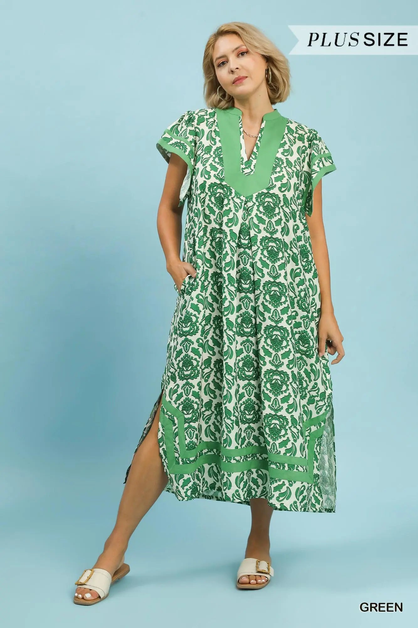Woman wearing a green floral dress on a blue background