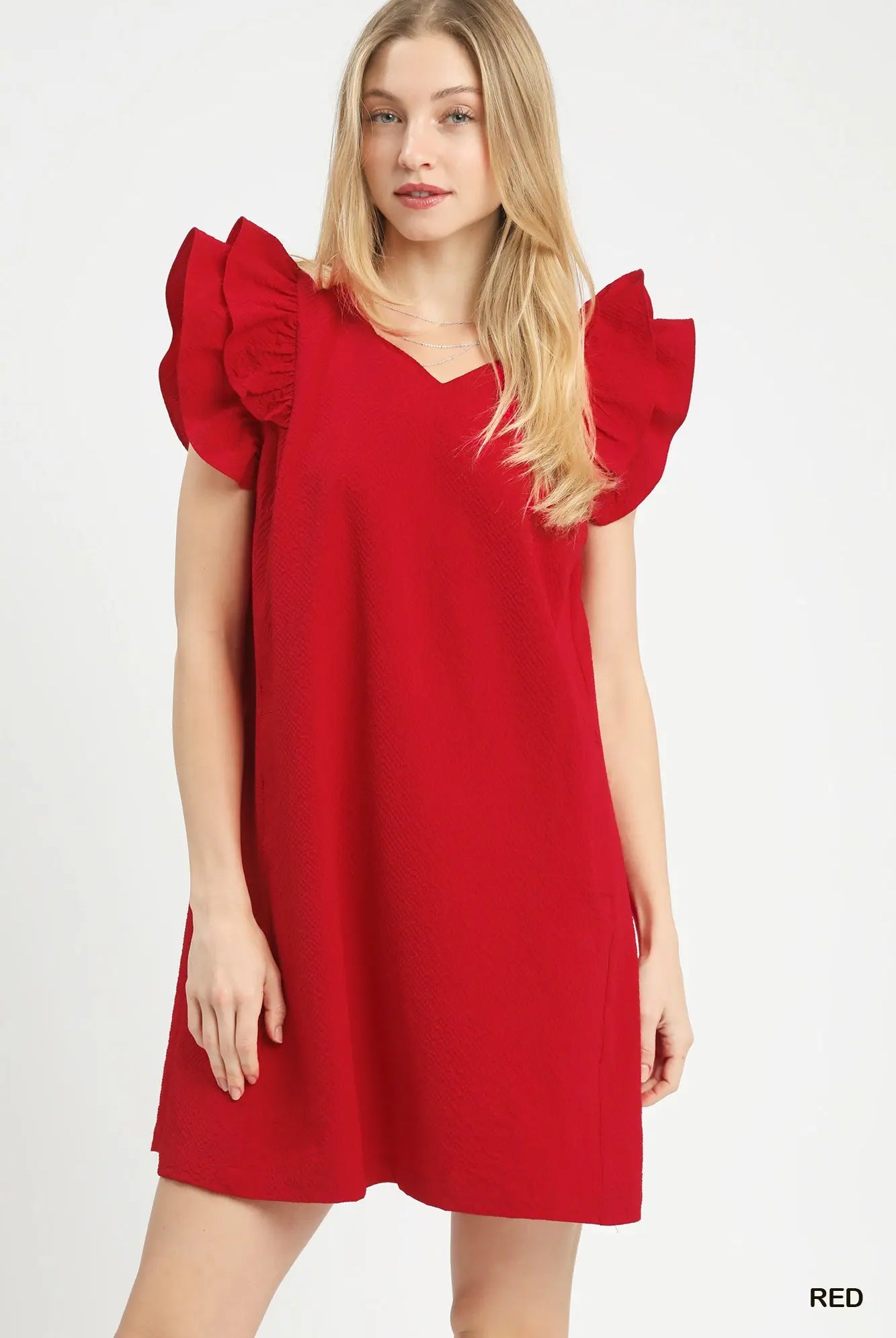 Woman wearing a red dress with ruffled sleeves