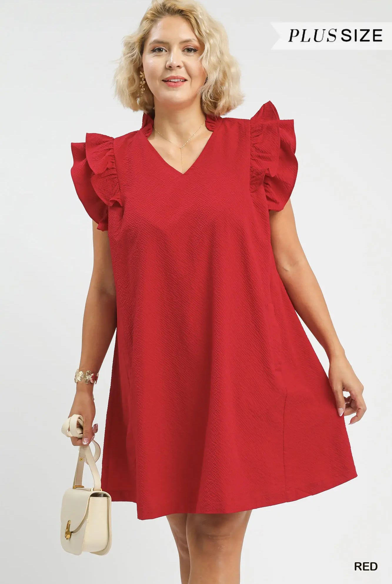 Woman wearing a red dress with ruffled sleeves