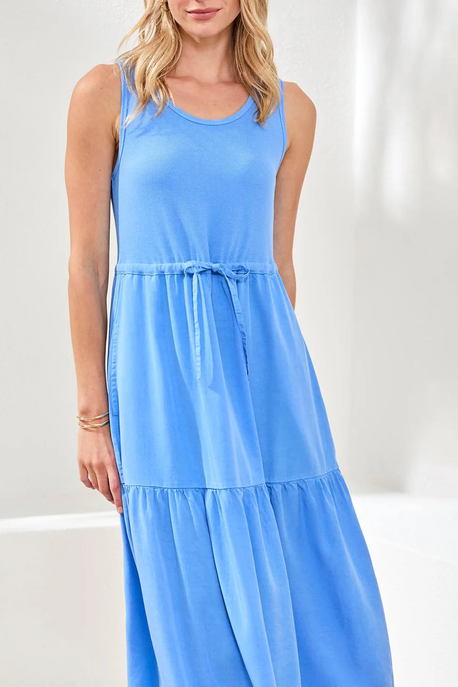 Woman wearing a blue sleeveless dress