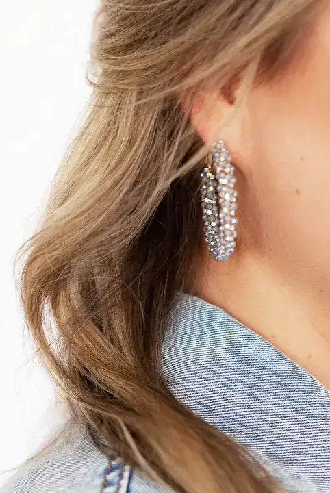 Blue and gold earrings on model