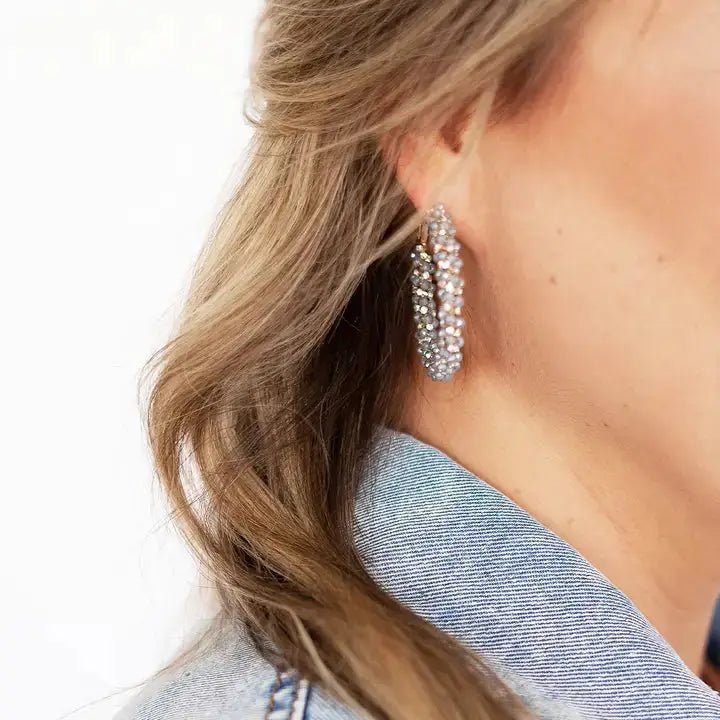 Blue and gold earrings on model