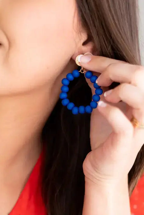 Model wearing royal blue earrings