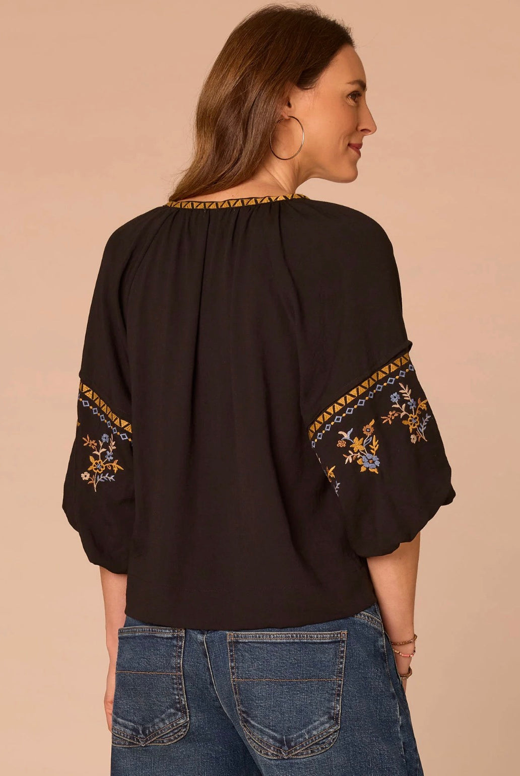 Back view of woman wearing black shirt and jeans