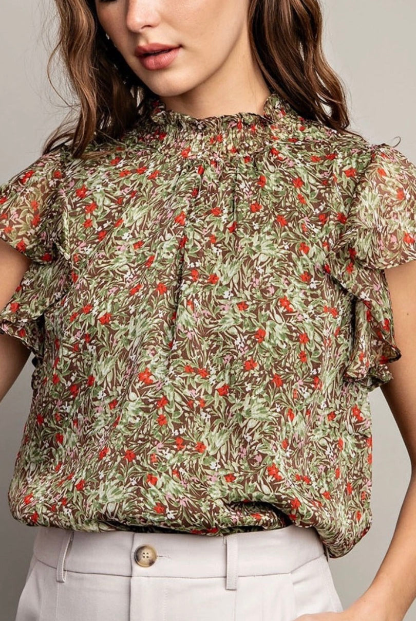 Front view of model wearing olive and floral tank with cream button