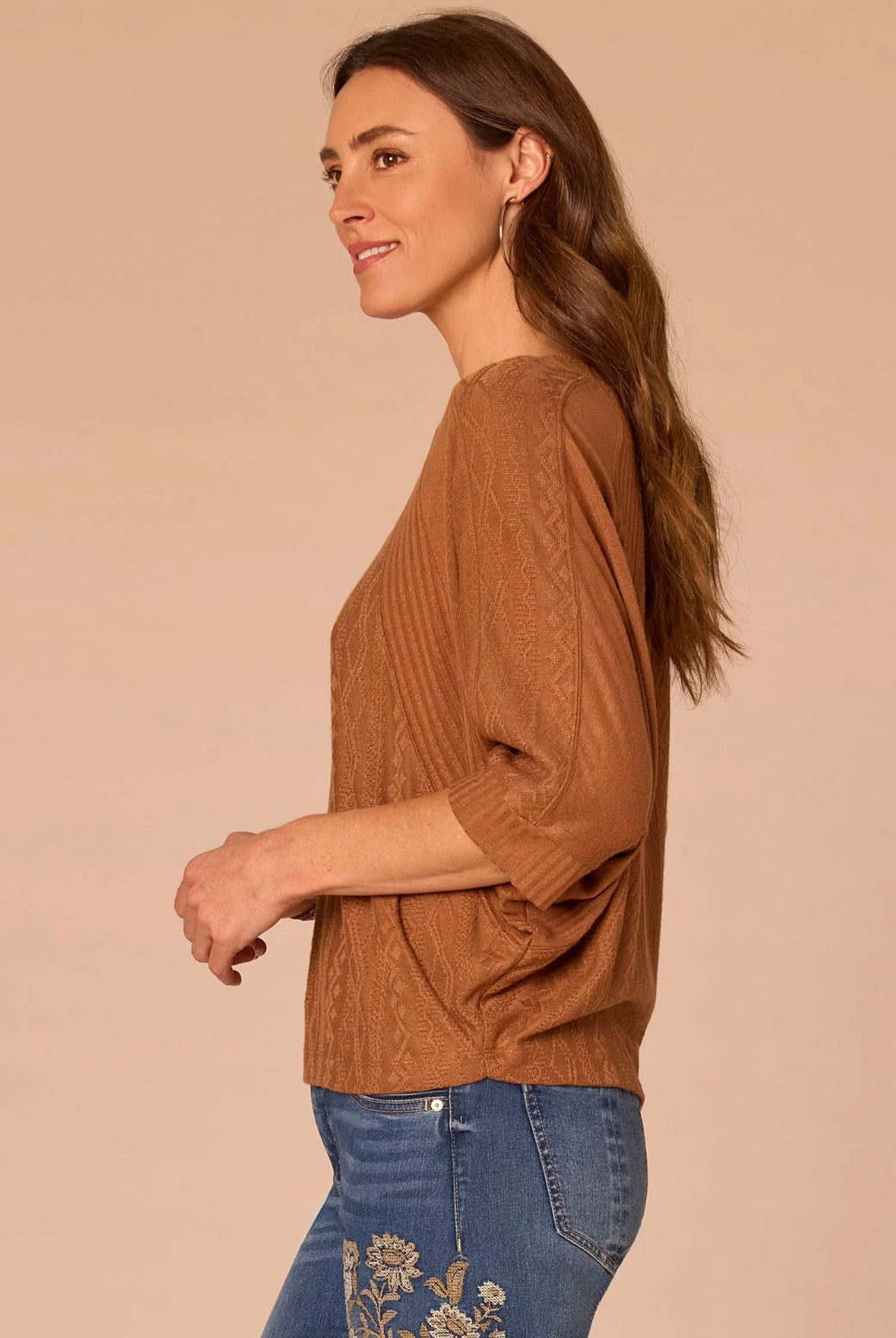Side view of woman wearing rust colored shirt