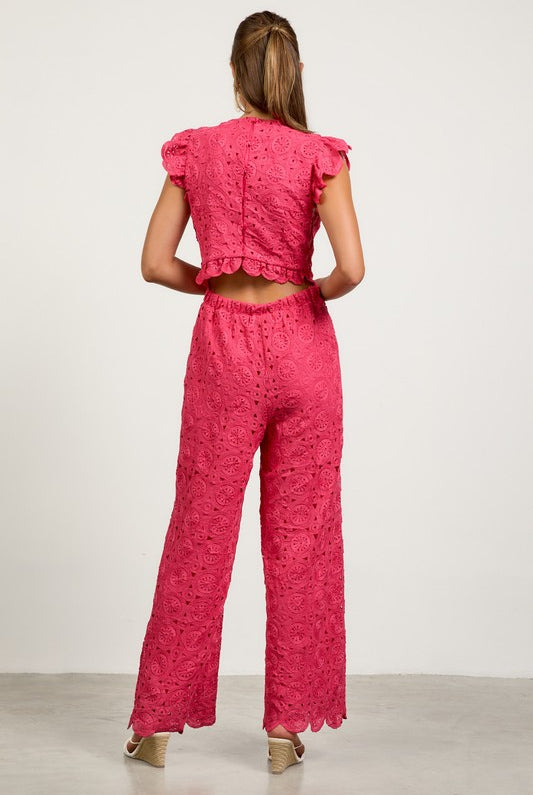 Woman wearing a pink lace outfit back view