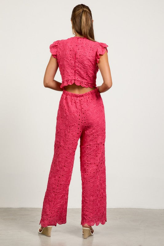 Woman wearing a pink lace outfit back view