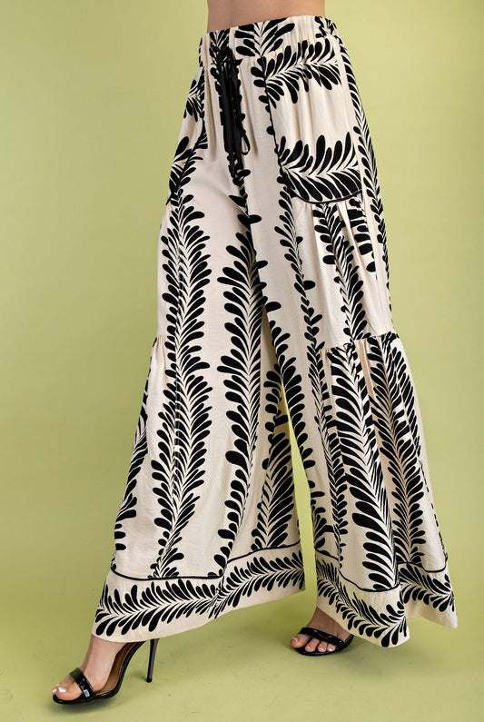 Black and white patterned pants on a green background