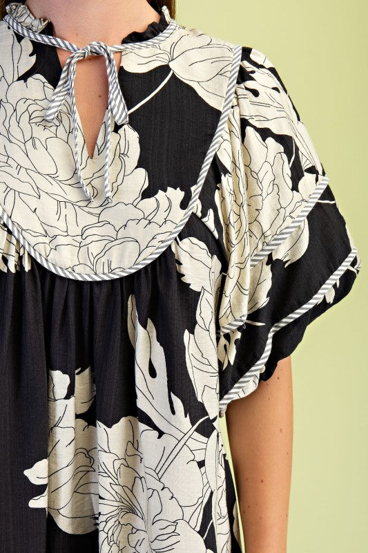 Black and white floral dress with a green background