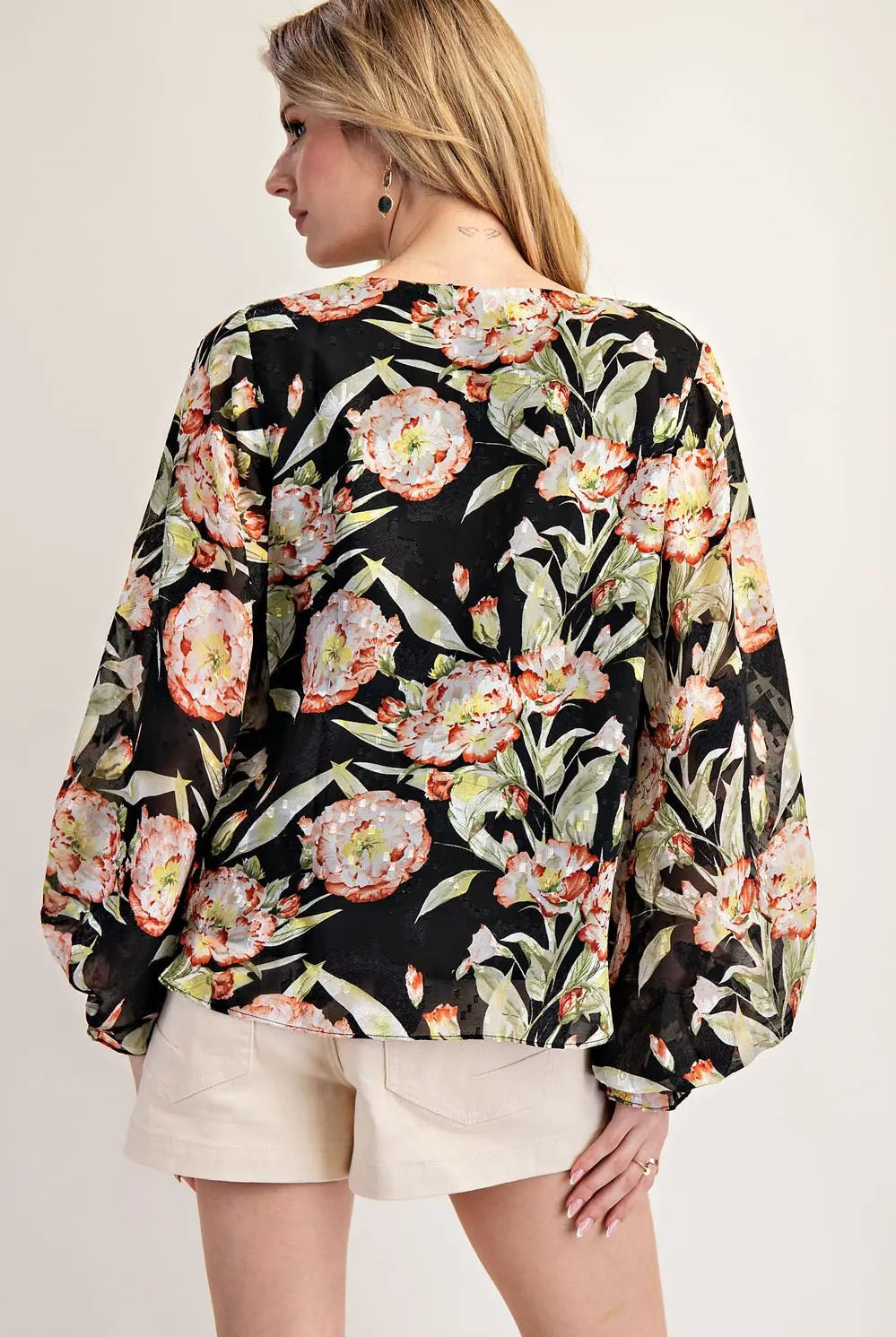 Value of model wearing black floral top and shorts