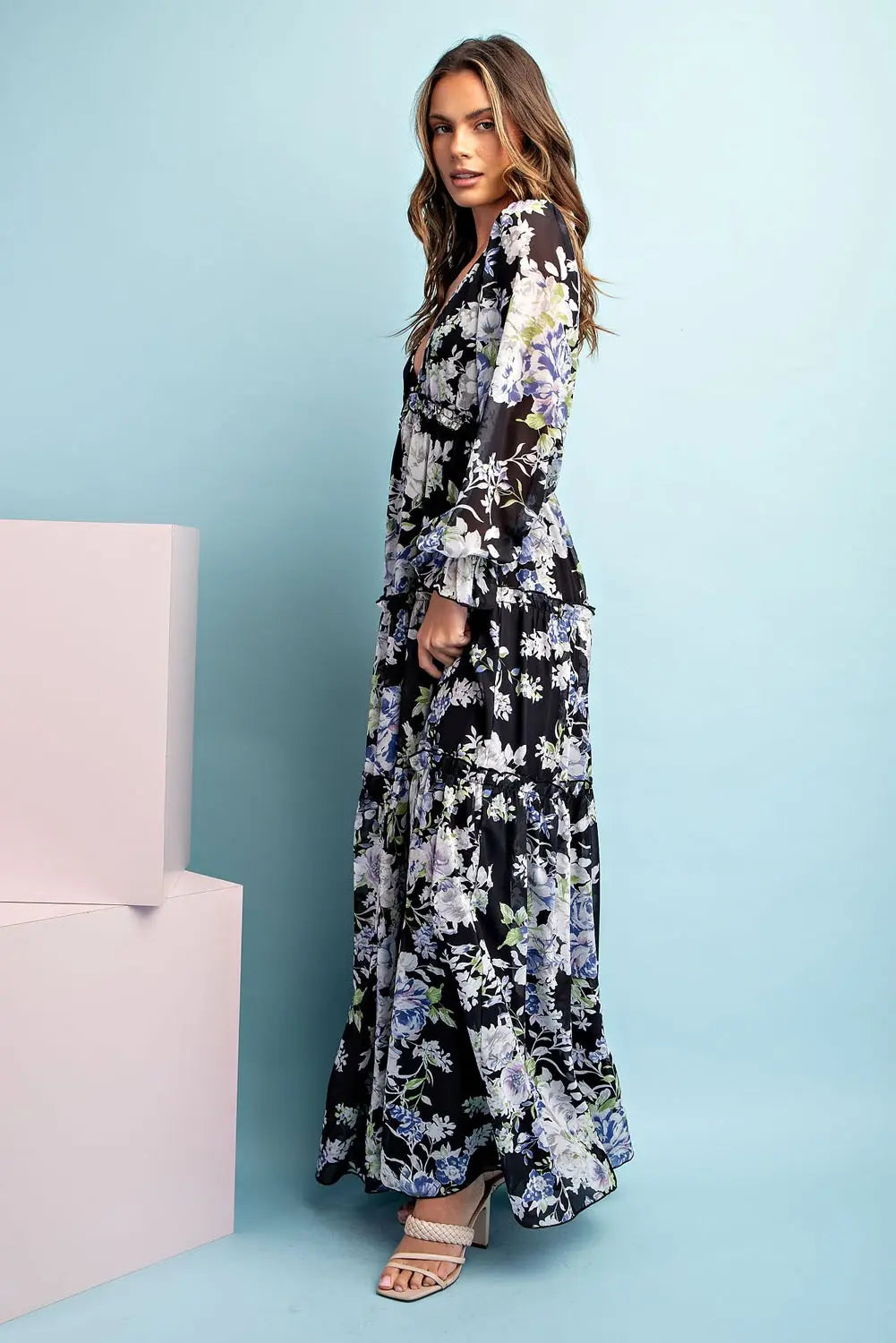 Side view of model wearing long sleeve maxi floral dress