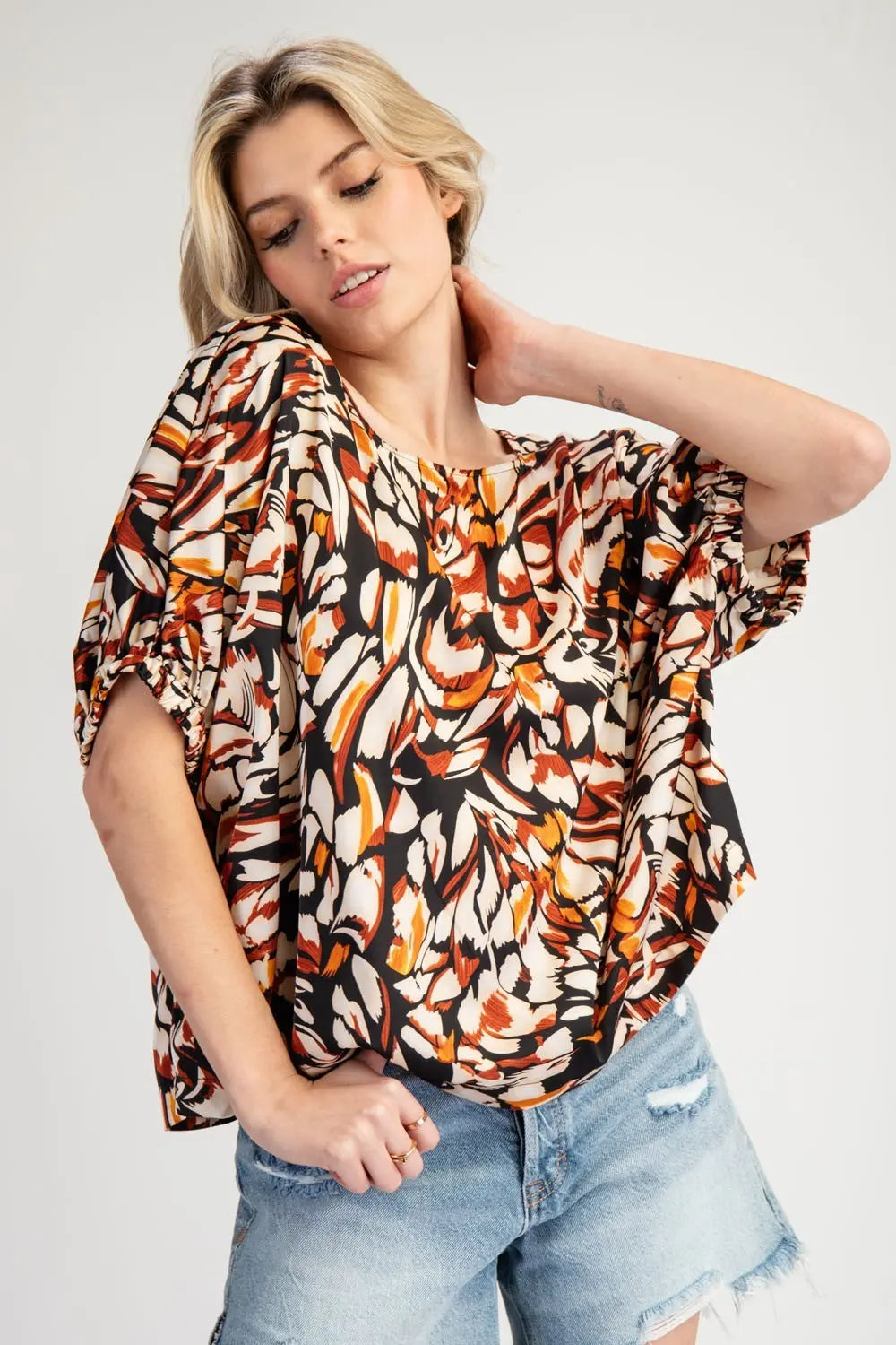 Model wearing printed shirt with Jean cutoff shorts