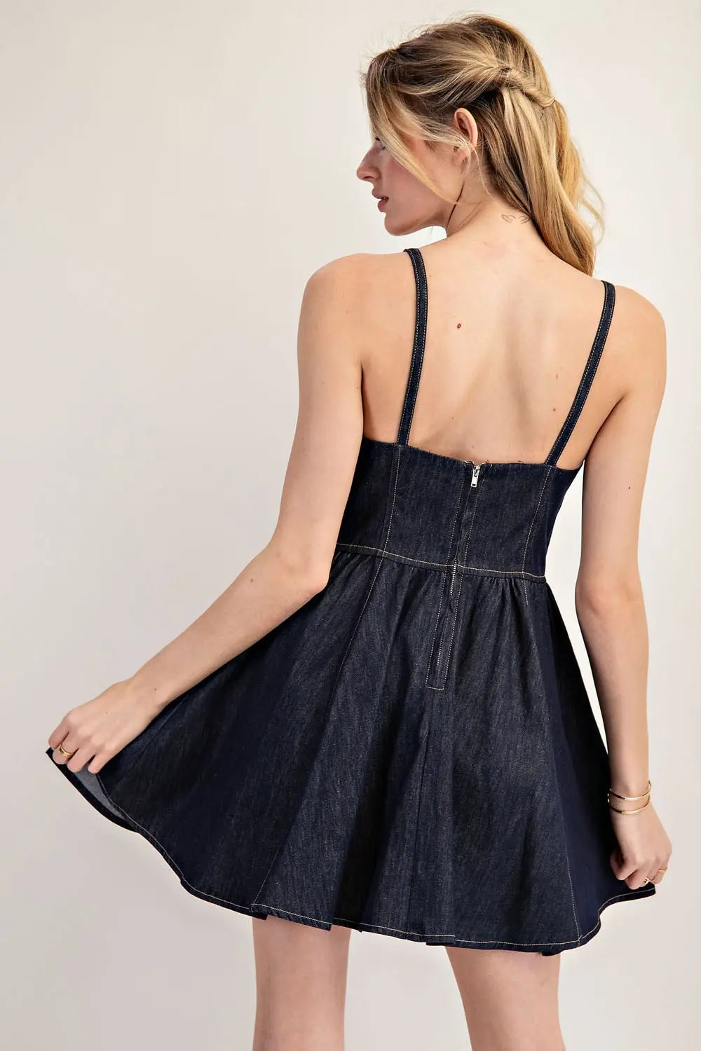 Back view of model wearing spaghetti strap, dark denim dress