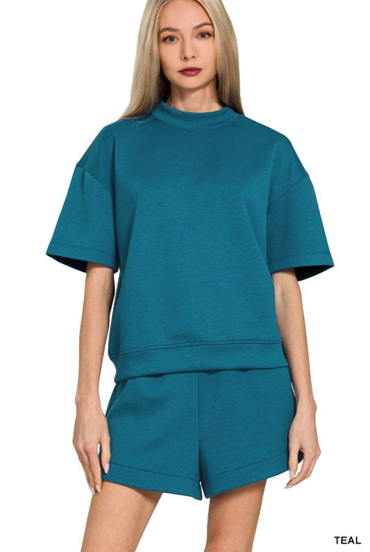Woman wearing teal shorts set