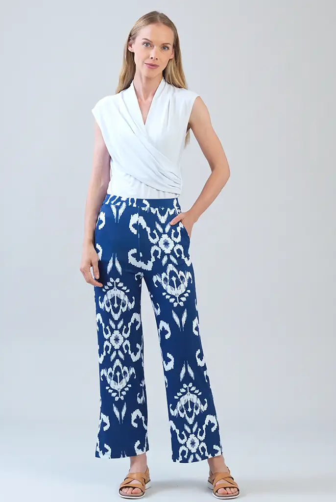 Model wearing white shirt with blue tile print motif pants