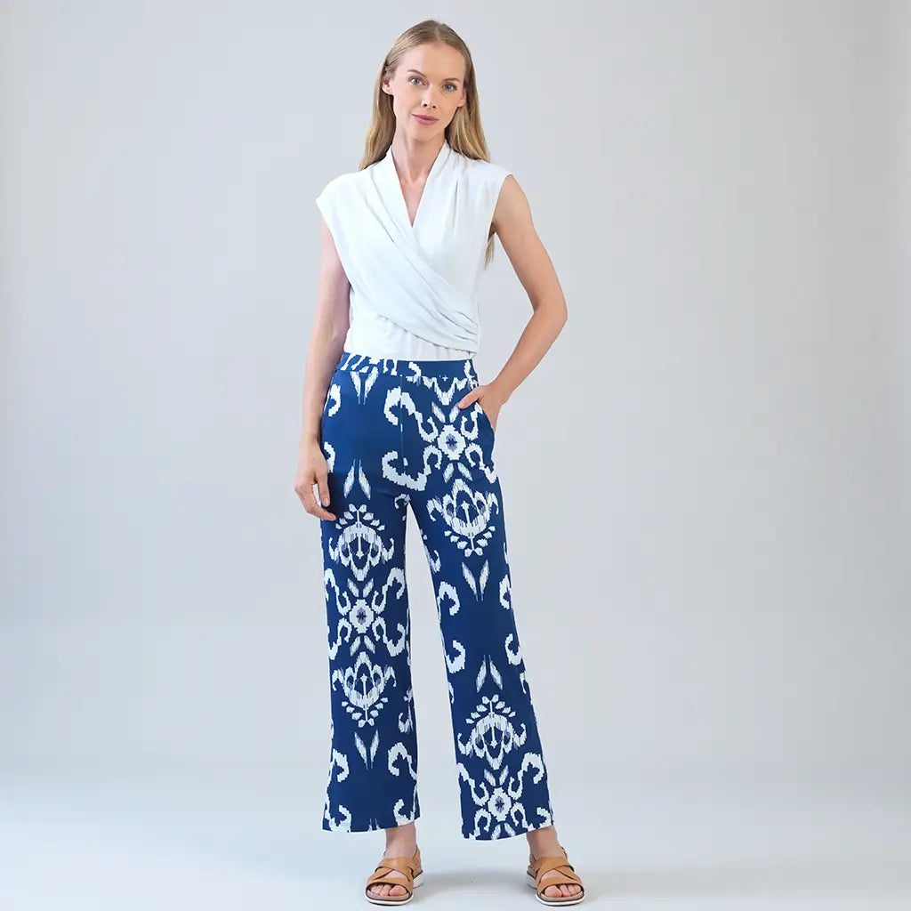 Model wearing white shirt with blue tile print motif pants