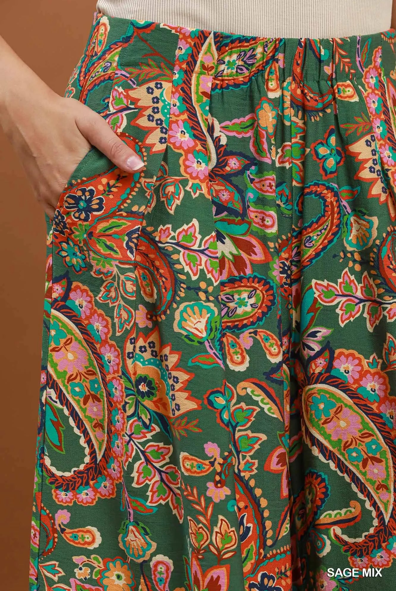 Colorful paisley-patterned pants with a brown background