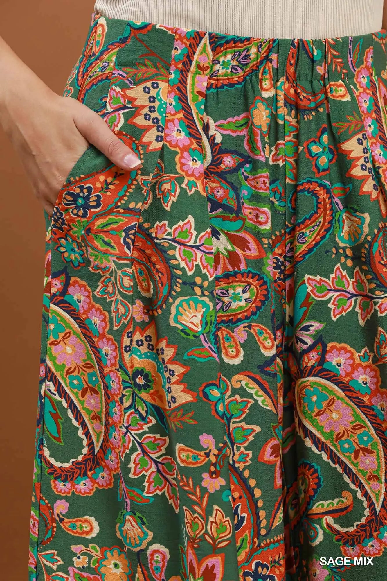 Colorful paisley-patterned pants with a brown background