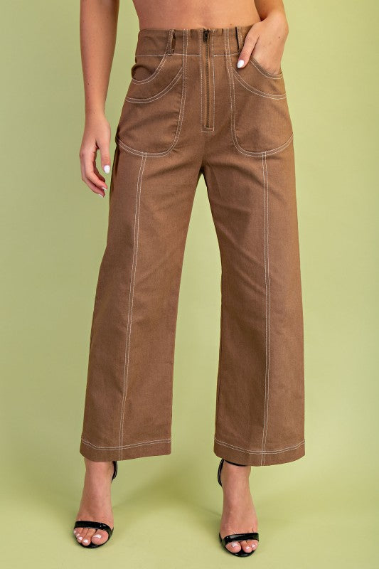 Brown wide-leg pants worn by a person on a green background