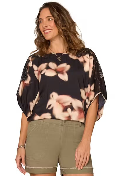 Model wearing dolman top and shorts on a white background.