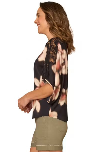 Side view Model wearing dolman top and shorts on a white background.