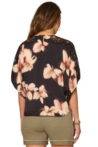 back view Model wearing dolman top and shorts on a white background.