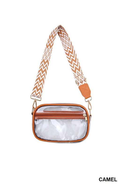 Clear pouch with brown leather accents and a patterned strap on a white background