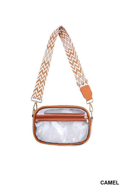 Clear pouch with brown leather accents and a patterned strap on a white background