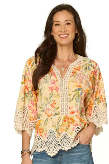 Woman wearing a floral blouse with lace details