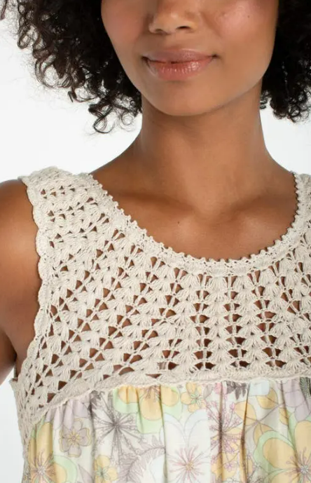 Woman wearing a floral dress beige crochet top