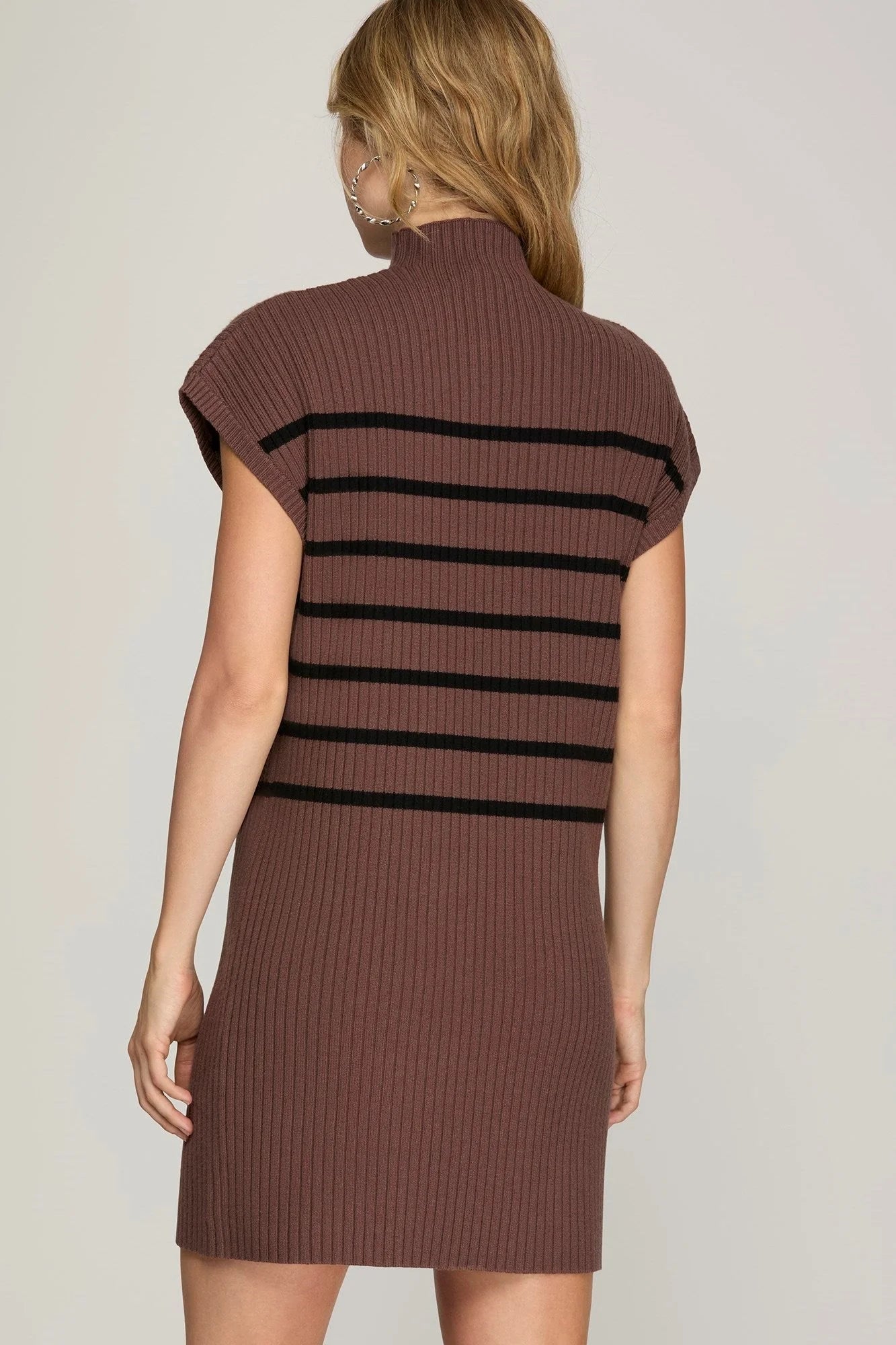 back view ofModel wearing chocolate mock neck dress with black stripes