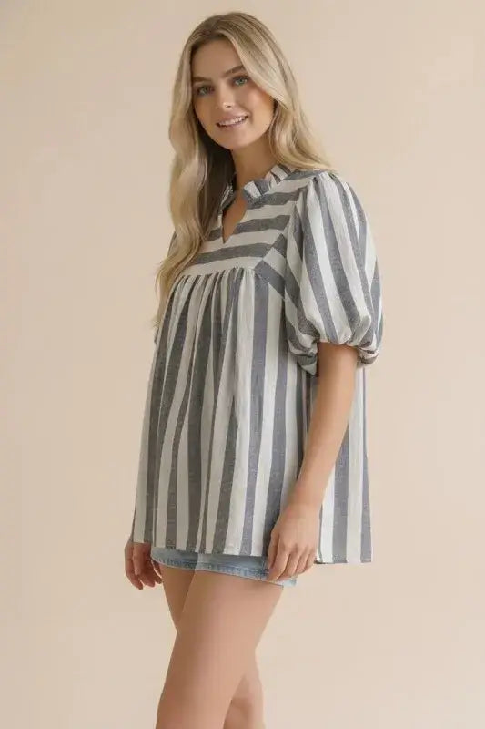 Woman wearing a striped shirt with bubble puff sleeves