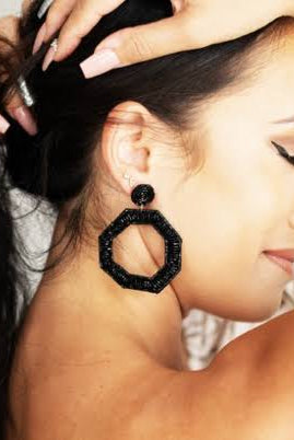 MODEL WEARING BLACK EARRINGS