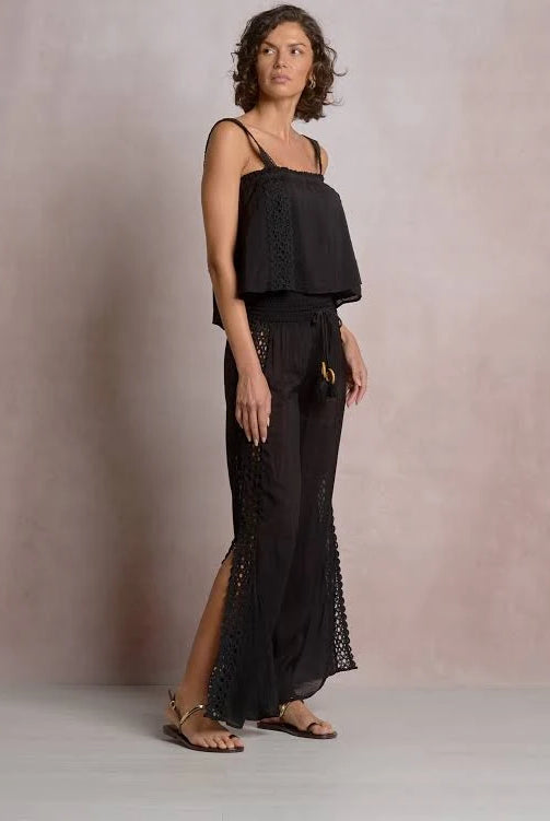 Side profile of woman wearing a black lace top