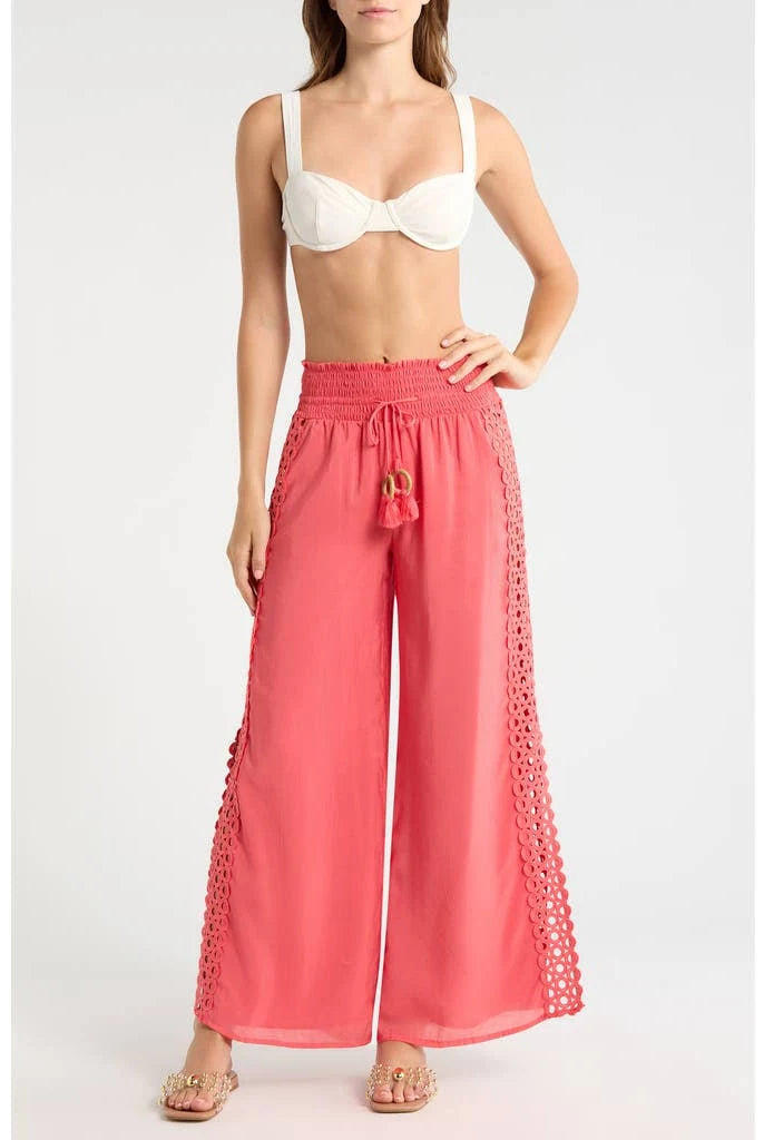 Woman wearing coral pants with lace details